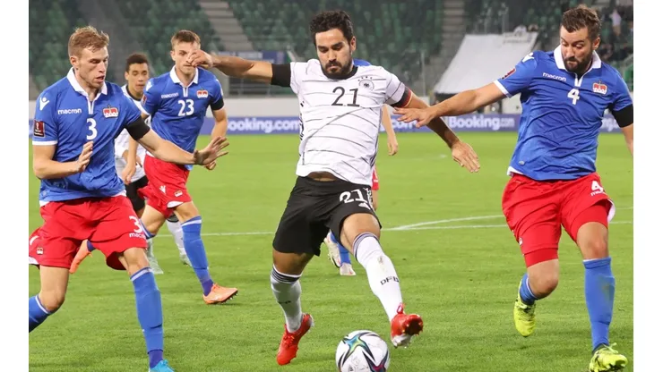Ilkay Gundogan of Germany (center) is put under pressure by Max Goppel (left) and Daniel Kaufmann (right) of Liechtenstein