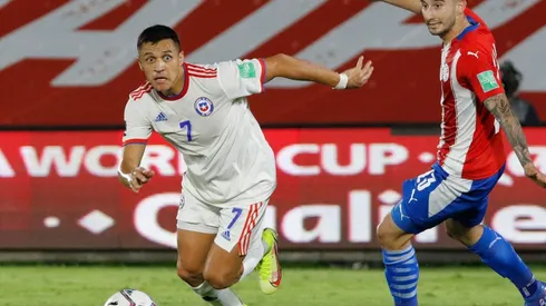 Alexis Sanchez of Chile (left) controls the ball during a match against Paraguay.