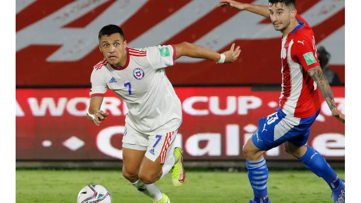 Alexis Sanchez of Chile (left) controls the ball during a match against Paraguay.