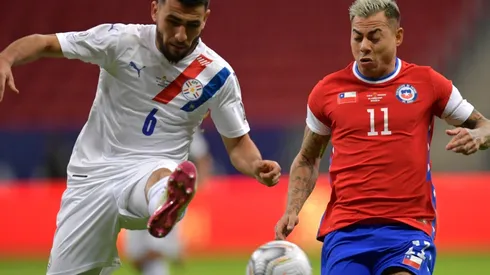 Junior Alonso of Paraguay fights for the ball with Eduardo Vargas of Chile.