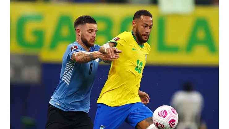 Neymar Jr. of Brazil fights for the ball with Nahitan Nandez of Uruguay