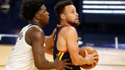 Anthony Edwards of Timberwolves (left) tries to steal the ball from Stephen Curry of Warriors