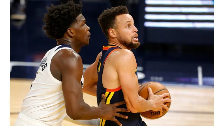 Anthony Edwards of Timberwolves (left) tries to steal the ball from Stephen Curry of Warriors