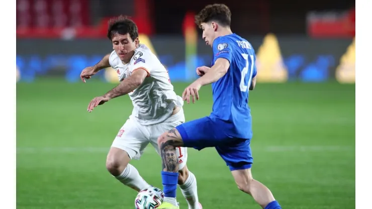 Mikel Oyarzabal of Spain (left) tries to steal the ball from Kostas Tsimikas of Greece