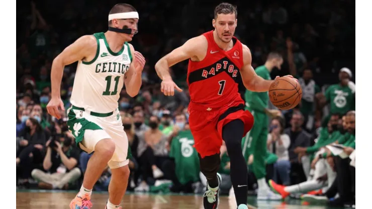 Payton Pritchard of the Boston Celtics (left) tries to stop Goran Dragic of the Raptors