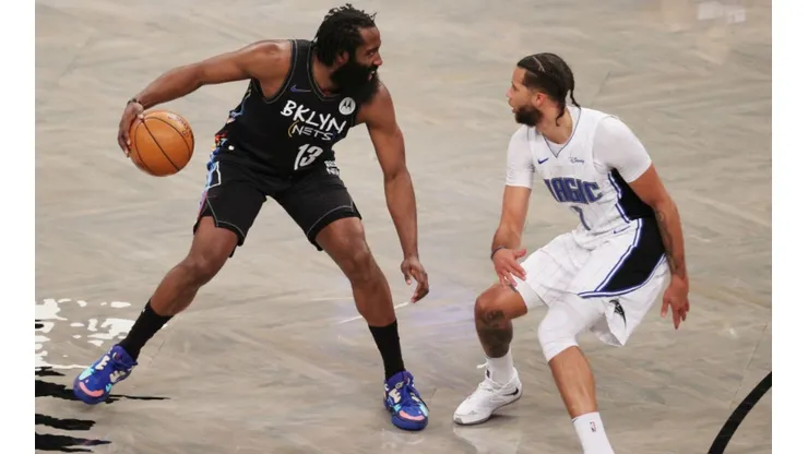 James Harden of the Nets (left) tries to pass drible Michael Carter-Williams of the Magic