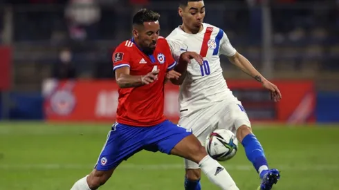 Mauricio Isla of Chile (left) fights for ball control with Miguel Almiron of Paraguay by ELVIS GONZÁLEZ;