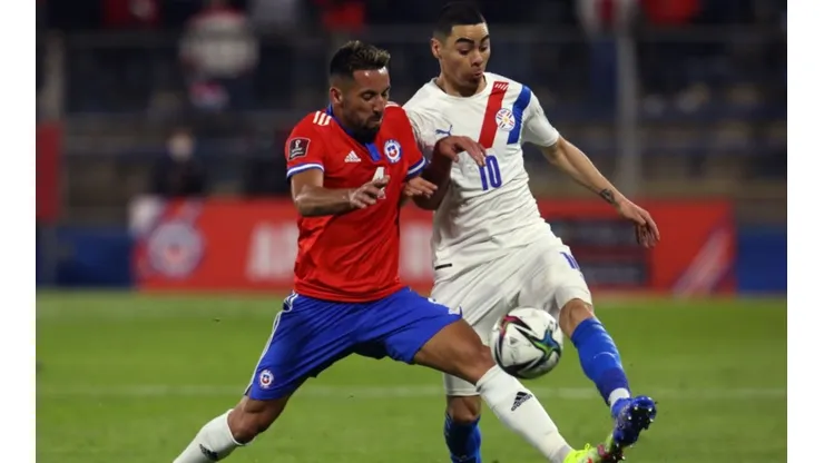 Mauricio Isla of Chile (left) fights for ball control with Miguel Almiron of Paraguay by ELVIS GONZÁLEZ;