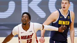 Bam Adebayo of Miami Heat (left) tries to avoid a offensive rebound against Nikola Jokic