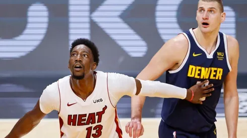Bam Adebayo of Miami Heat (left) tries to avoid a offensive rebound against Nikola Jokic