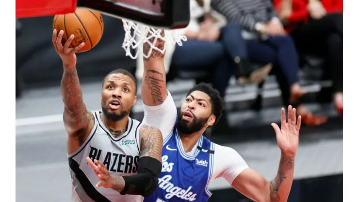 Damian Lillidard of Portland (left) tries to score in front of Anthony Davis of Los Angeles