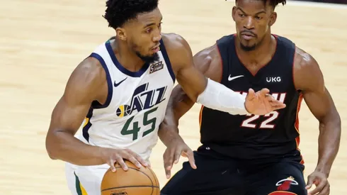 Donovan Mitchell of Utah Jazz (left) tries to pass drible Jimmy Butler of Miami Heat