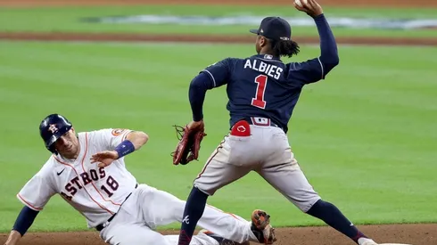 Ozzie Albies #1 of the Atlanta Braves attempts to turn the double play after making the putout on Jason Castro #18 of the Houston Astros