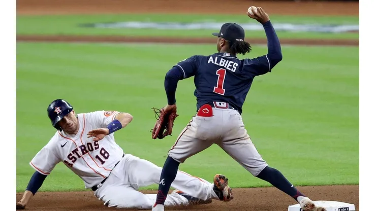 Ozzie Albies #1 of the Atlanta Braves attempts to turn the double play after making the putout on Jason Castro #18 of the Houston Astros