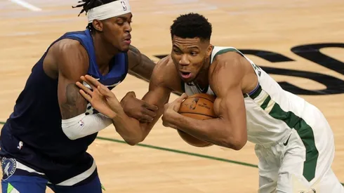 Jarred Vanderbilt of Timberwolves (left) tries to stop Giannis Antetokounmpo