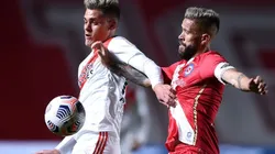 Federico Girotti of River (left) fights for ball possession against Miguel Torren of Argentinos Juniors