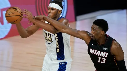 Myles Turner of the Pacers (left) tries to avoid Bam Adebayo of the Heat