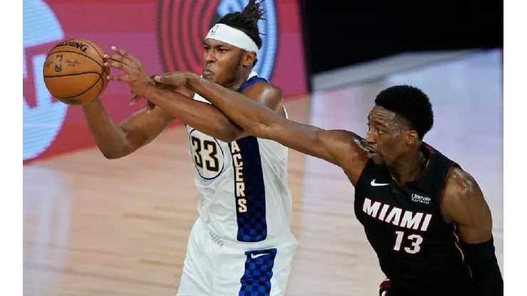 Myles Turner of the Pacers (left) tries to avoid Bam Adebayo of the Heat