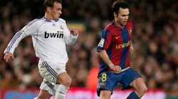 Andres Iniesta (R) of Barcelona controls the ball flanked by Wesley Sneijder of Real Madrid