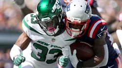 Adrian Colbert of the New York Jets (left) tries to stop James White of the New England Patriots