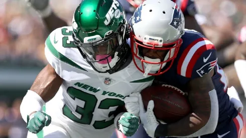 Adrian Colbert of the New York Jets (left) tries to stop James White of the New England Patriots