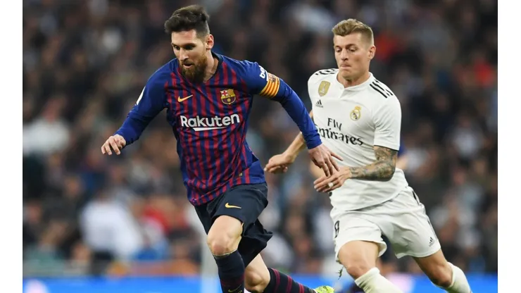 Lionel Messi and Toni Kroos in action during a Barcelona v Real Madrid El Clasico derby in 2019.