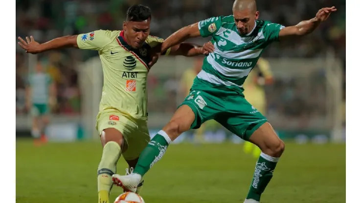 Roger Martinez of Club America (left) fights for ball control with Matheus Doria of Santos Laguna