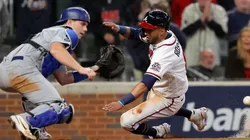 Eddie Rosario #8 of the Atlanta Braves slides safely past Will Smith #16 of the Los Angeles Dodgers