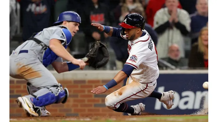 Eddie Rosario #8 of the Atlanta Braves slides safely past Will Smith #16 of the Los Angeles Dodgers