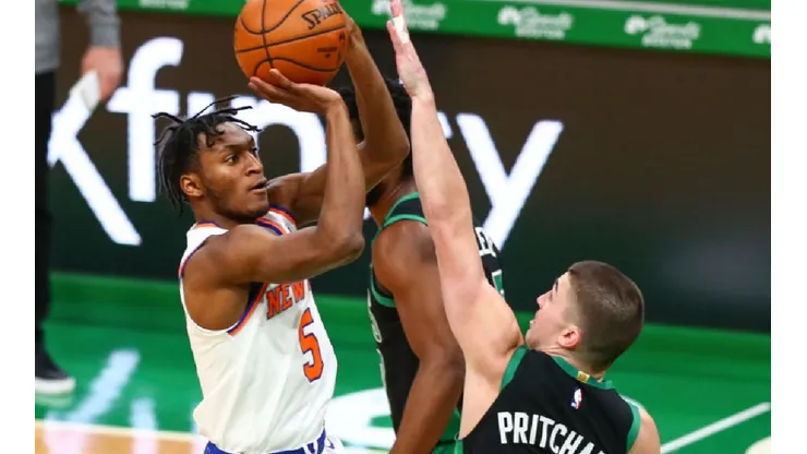 Immanuel Quickley of the Knicks (left) tries a jump shot in front of Payton Pritchard of the Celtics