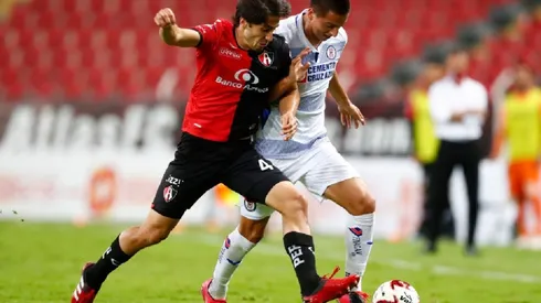 Jose Abella of Atlas (left) fights for ball control against Roberto Alvarado of Cruz Azul