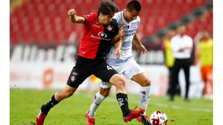 Jose Abella of Atlas (left) fights for ball control against Roberto Alvarado of Cruz Azul