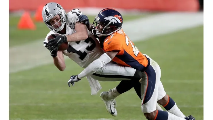 Hunter Renfrow of the Raiders (left) tries to gain more yards against Will Parks of the Broncos by Matthew Stockman