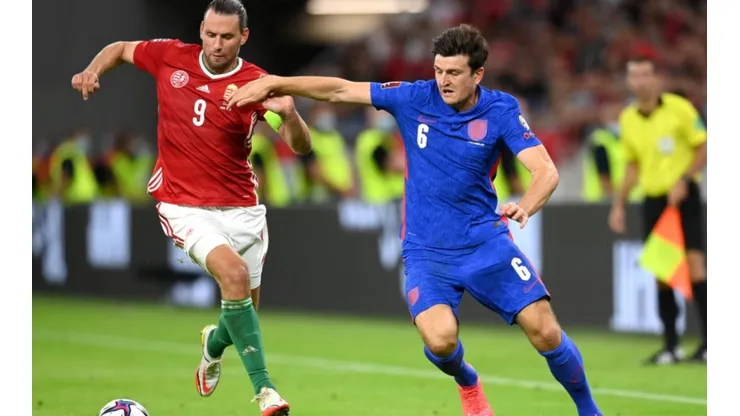 Adam Szalai of Hungary (left) fights for ball control against Harry Maguire of England