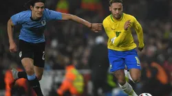 Edison Cavani of Uruguay (left) tries to stop Neymar of Brazil