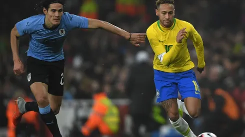 Edison Cavani of Uruguay (left) tries to stop Neymar of Brazil