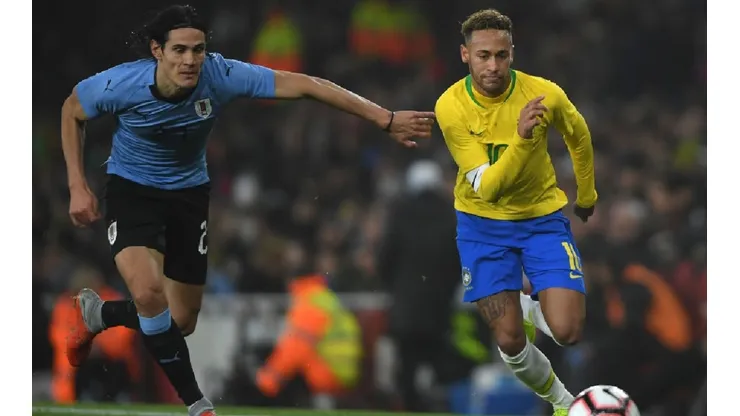 Edison Cavani of Uruguay (left) tries to stop Neymar of Brazil