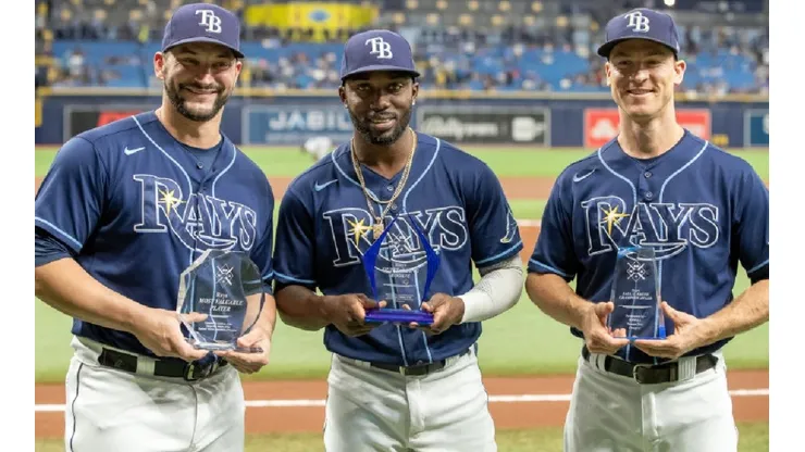 Mike Zunino, Randy Arozarena, Joey Wendle holding their individual team Awards