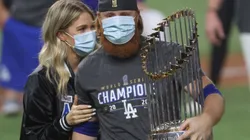 Kourtney Pogue and Justin Turner of the Dodger (right) holding the Commissioner's Trophy after winning MLB championship.