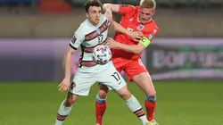 Diogo Jota of Portugal (left) holds position against Laurent Jans of Luxembourg