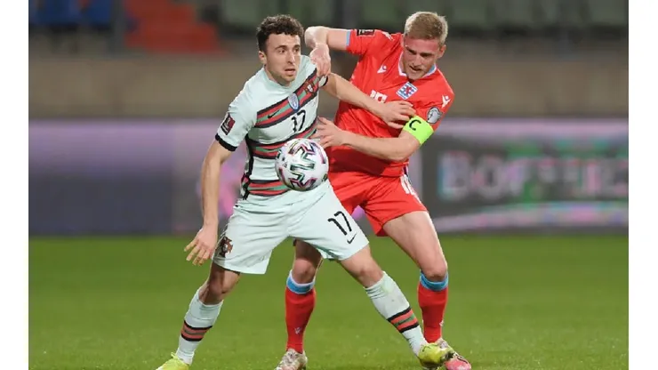 Diogo Jota of Portugal (left) holds position against Laurent Jans of Luxembourg