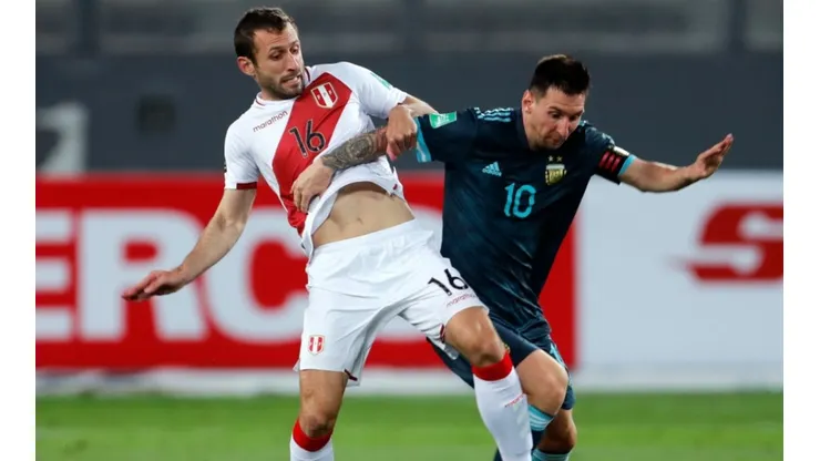 Horacio Calcaterra of Peru (left) tries to hold Lionel Messi of Argentina