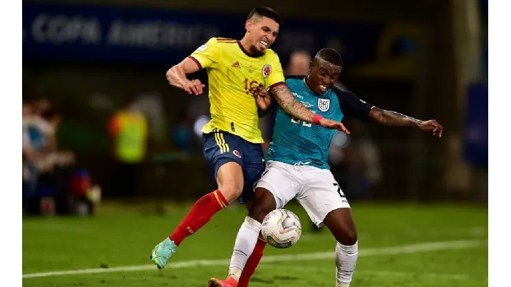 Daniel Muñoz of colombia (left) tries to block Sebastian Mendez of Ecuador