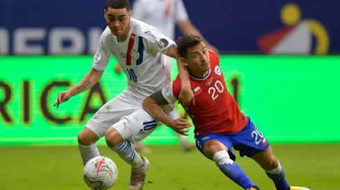 Paraguay's Miguel Almiron (left) struggles for the ball with Chile's Charles Aranguiz.