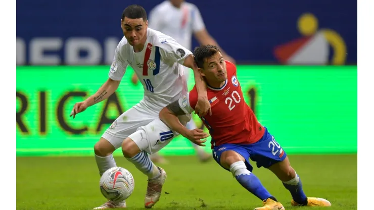 Paraguay's Miguel Almiron (left) struggles for the ball with Chile's Charles Aranguiz.