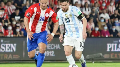 Lionel Messi of Argentina fights for the ball with Jorge Morel of Paraguay.