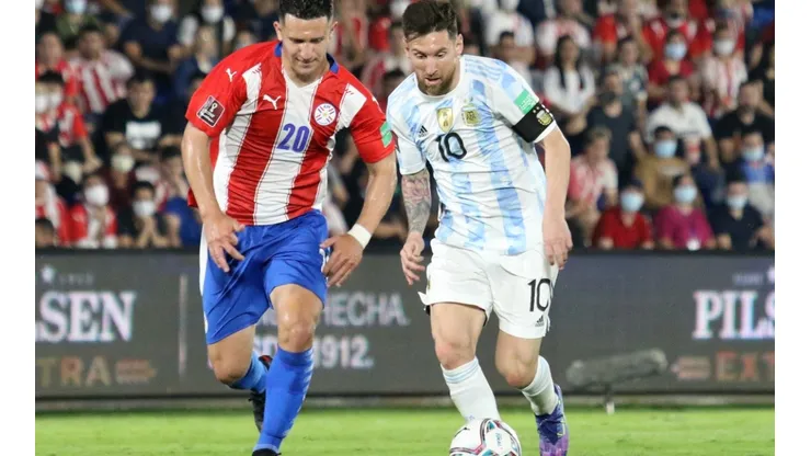 Lionel Messi of Argentina fights for the ball with Jorge Morel of Paraguay.