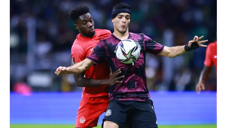 Alphonso Davies of Canada battles for possesion with Raúl Jimenez of Mexico.