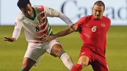 Roland Alberg of Suriname (left) battles with Samuel Piette of Canada (right)
