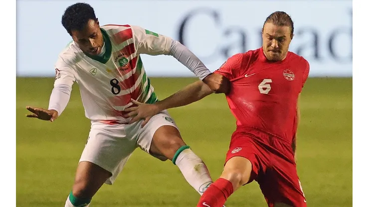 Roland Alberg of Suriname (left) battles with Samuel Piette of Canada (right)